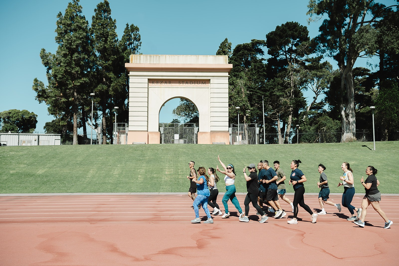 Bootcamp group running a lap together past the Kezar Stadium arch