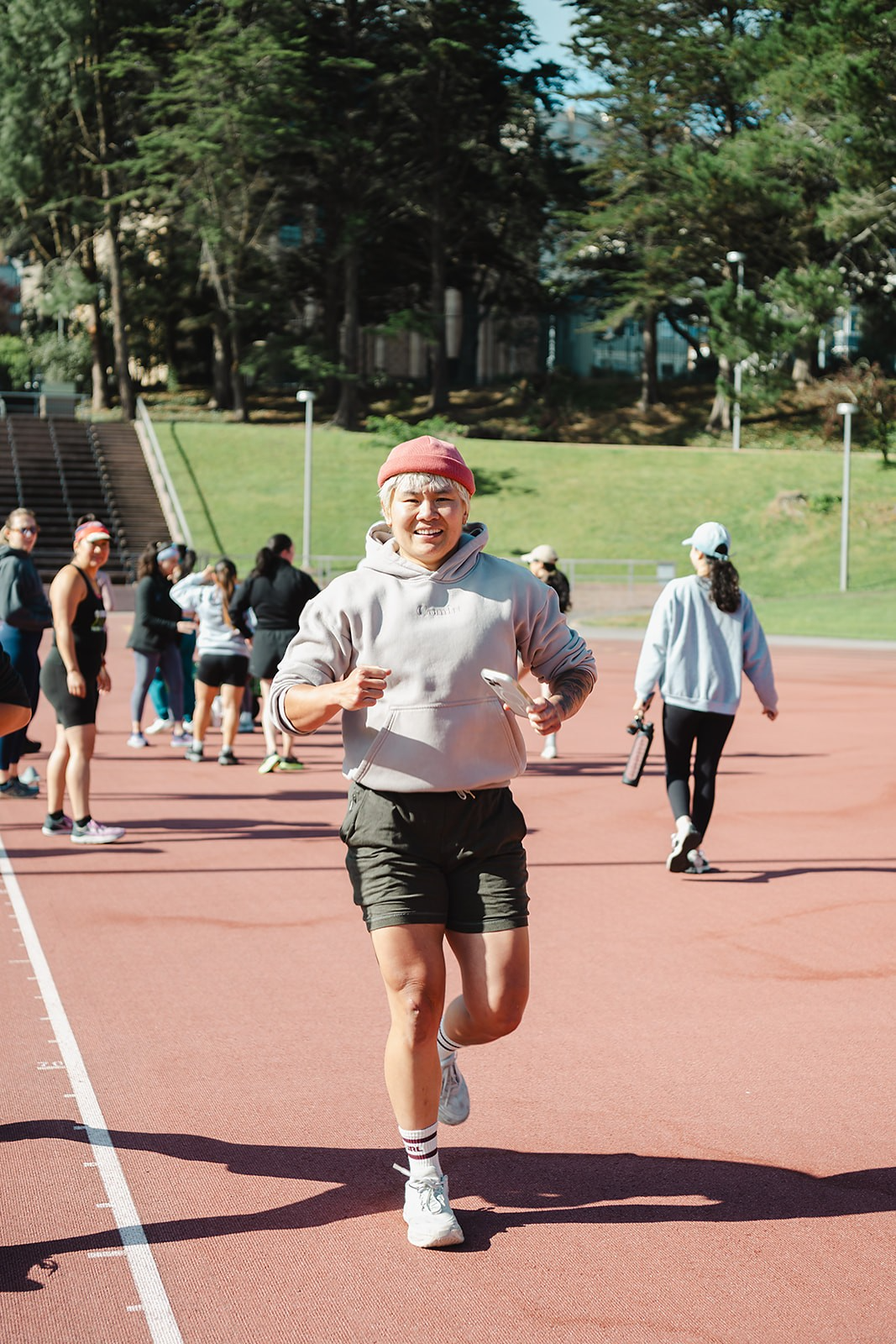 Nan, founder of Nanstop Fitness, running on an outdoor track during a group bootcamp