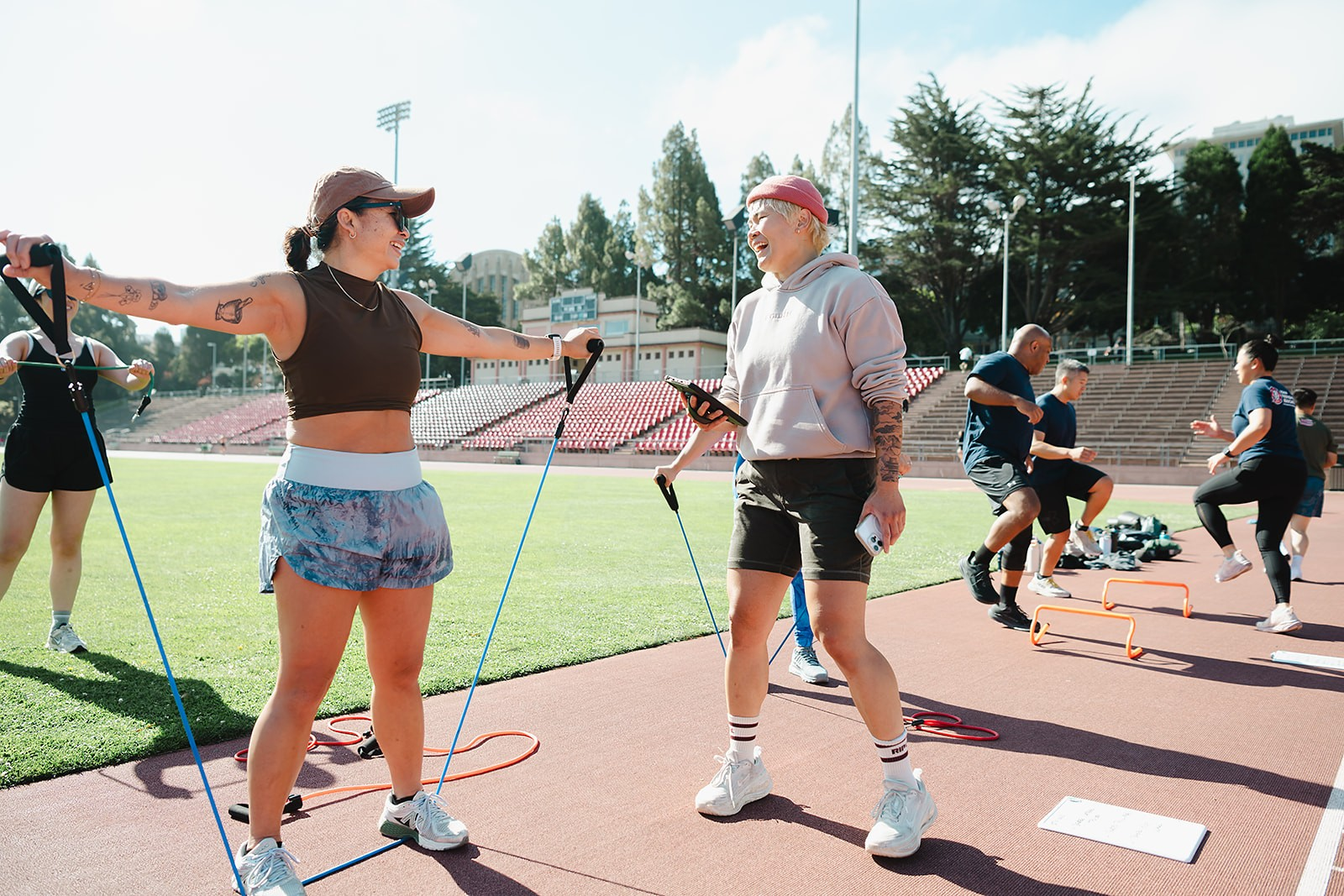Two members laughing during a resistance band warm up