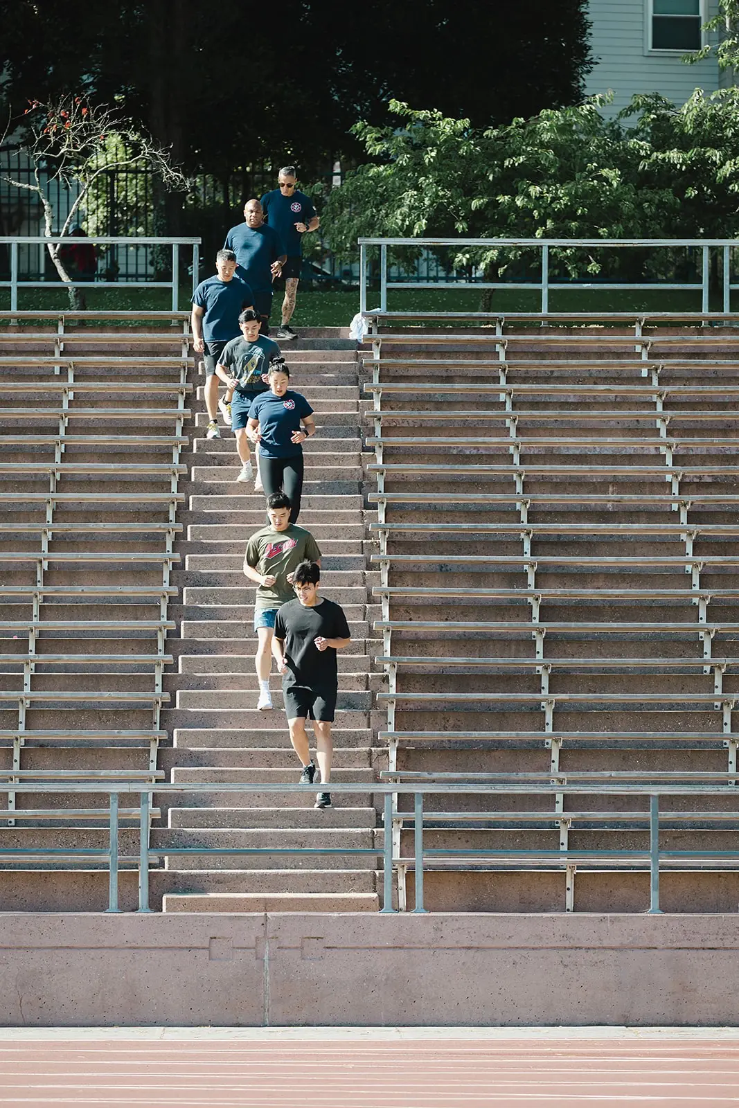 Bootcamp members running stadium stairs in single file